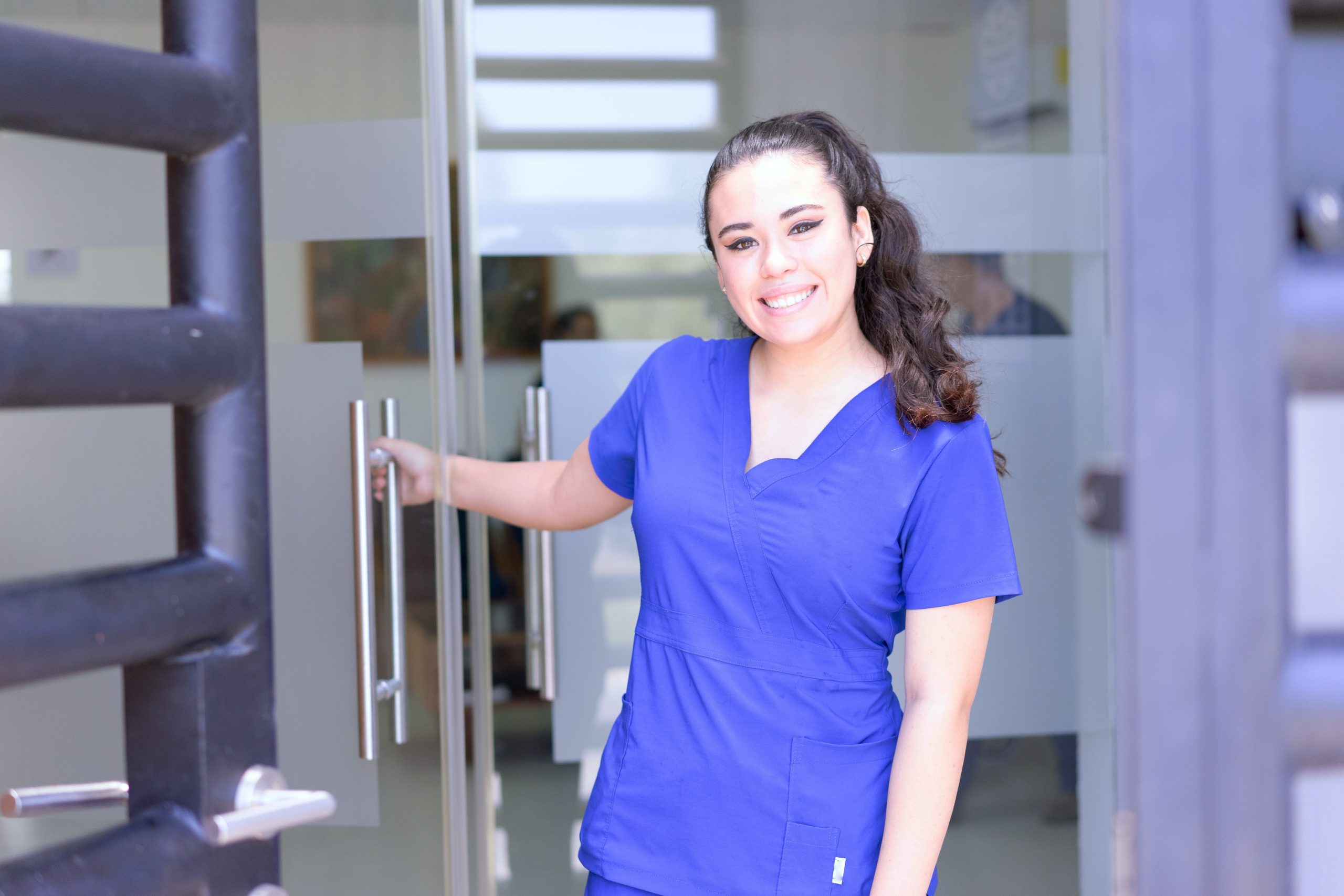A nurse opening a door while finding a fulfilling career and high-paying job.